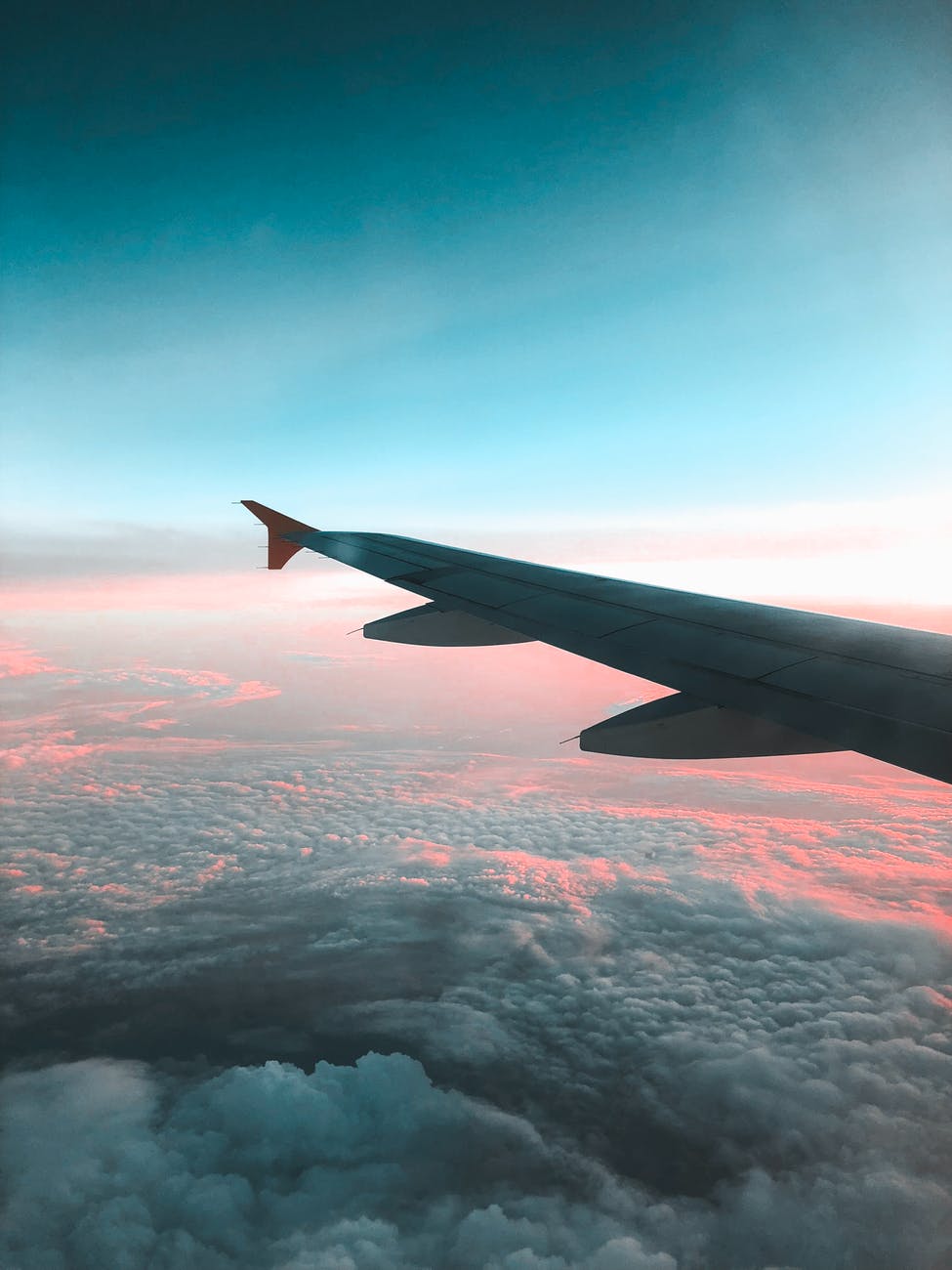 view of airliner wing above the clouds